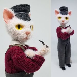 Miniature cat fisherman. 
Wire, super sculpey, acrylic paint, flock fiber, fabric and yarn. 